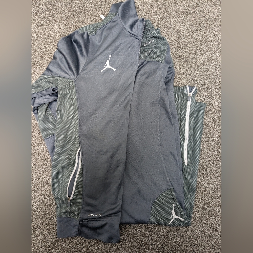 Gray Jordan pants and zip up hoodie set.